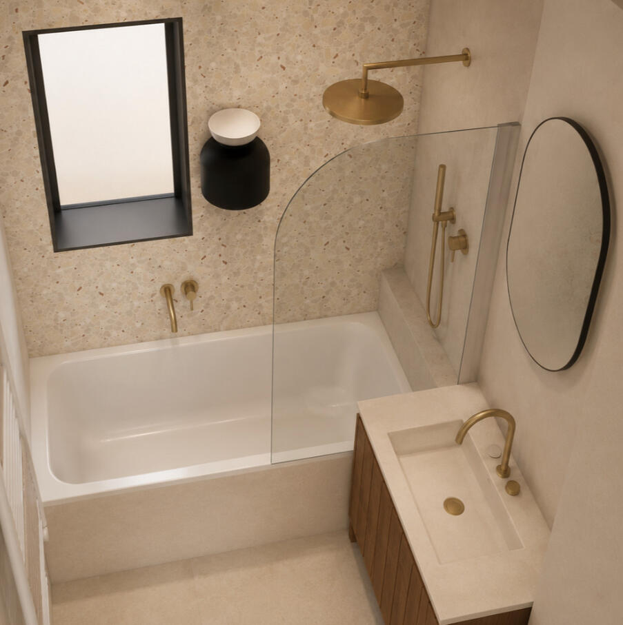 Salle de bain avec baignoire encastrée, robinetterie dorée et carrelage terrazzo, rénovation Atelier Luzons